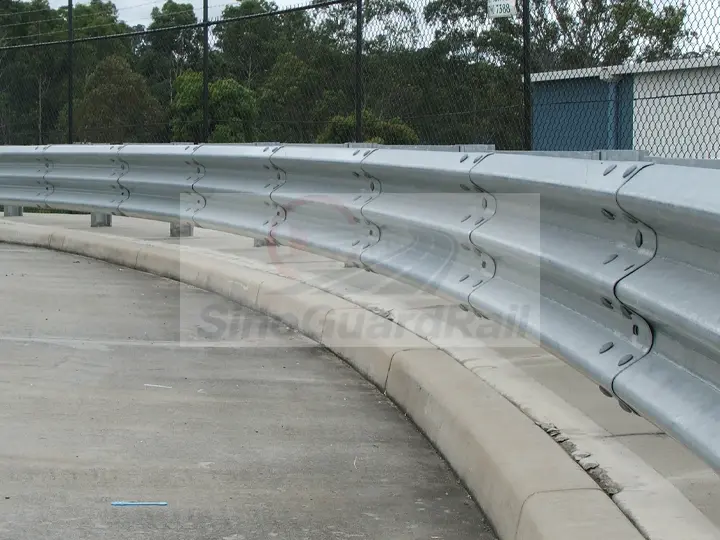 Installed thrie-beam guardrail with overlapping rail connections