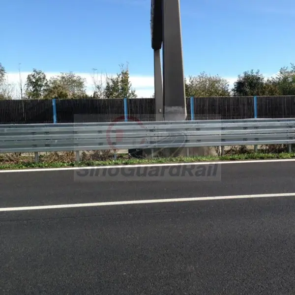 Installed galvanized highway guardrail showing continuous rail alignment, posts and connections
