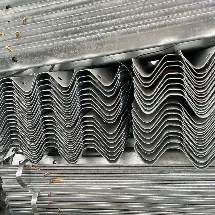 Close-up of stacked galvanized W-beam guardrail profiles and zinc-coated surfaces