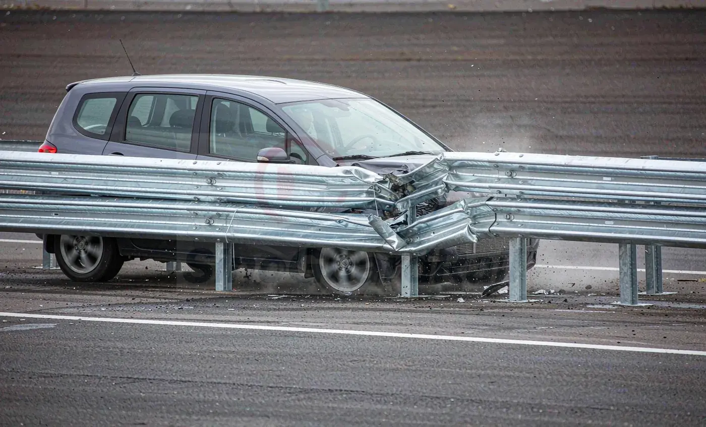 Full-scale vehicle impact test against a steel road safety barrier on an outdoor test track